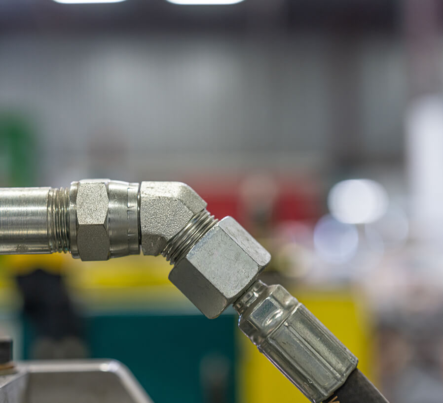 Metal SAE and NPT threaded hydraulic fittings and elbow connections used on tank mount suction strainers
